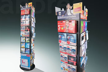 Drehbarer Bodenverkaufsständer mit Lochwandhaken zur Produktanordnung und austauschbaren Magnetblenden als Topper.